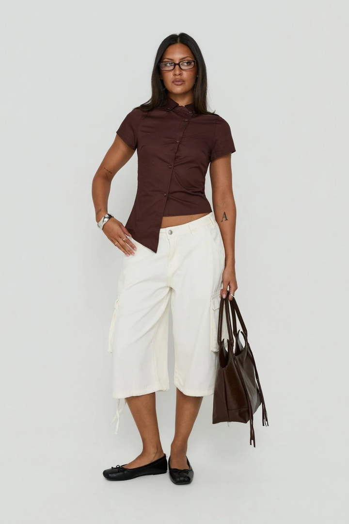 Model wearing women's wide leg cargo shorts in urban setting