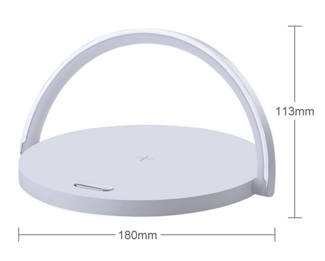 Modern desk lamp and wireless phone charger illuminating a contemporary bedside table