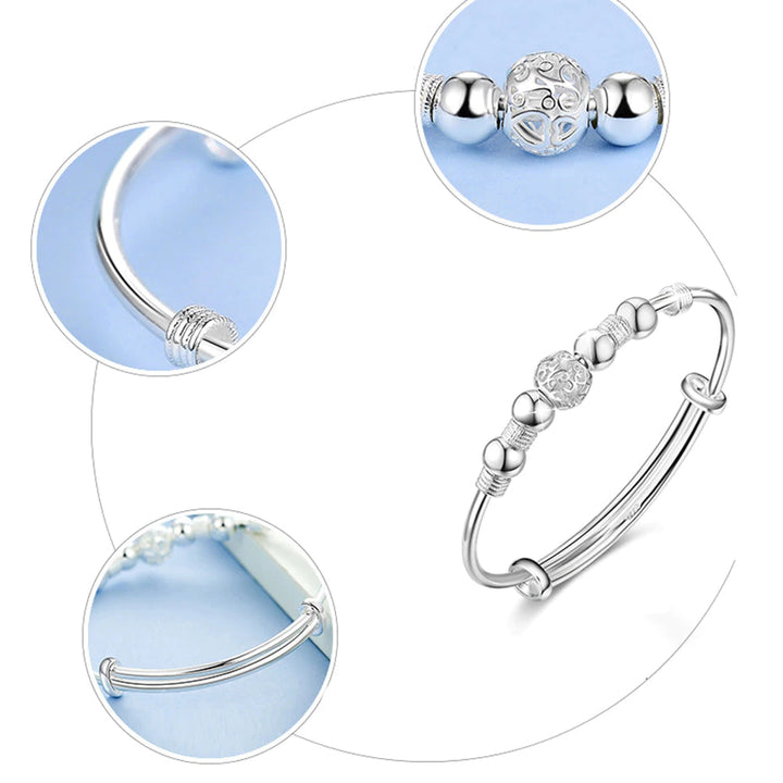 Women's silver lucky beads adjustable charm bracelet on white background