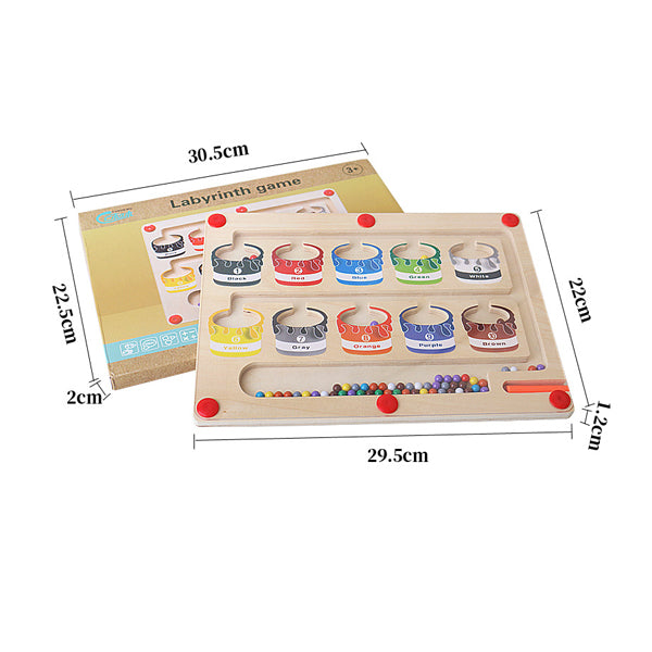 Toddler holding magnetic wand to guide beads through the numbers board