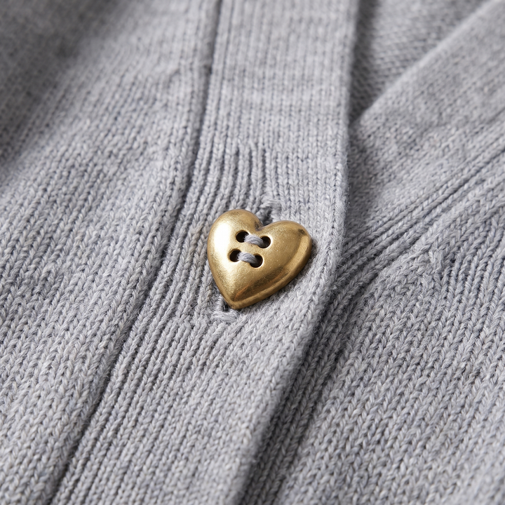 Close-up of the heart-shaped buttons on a chic women's knit cardigan