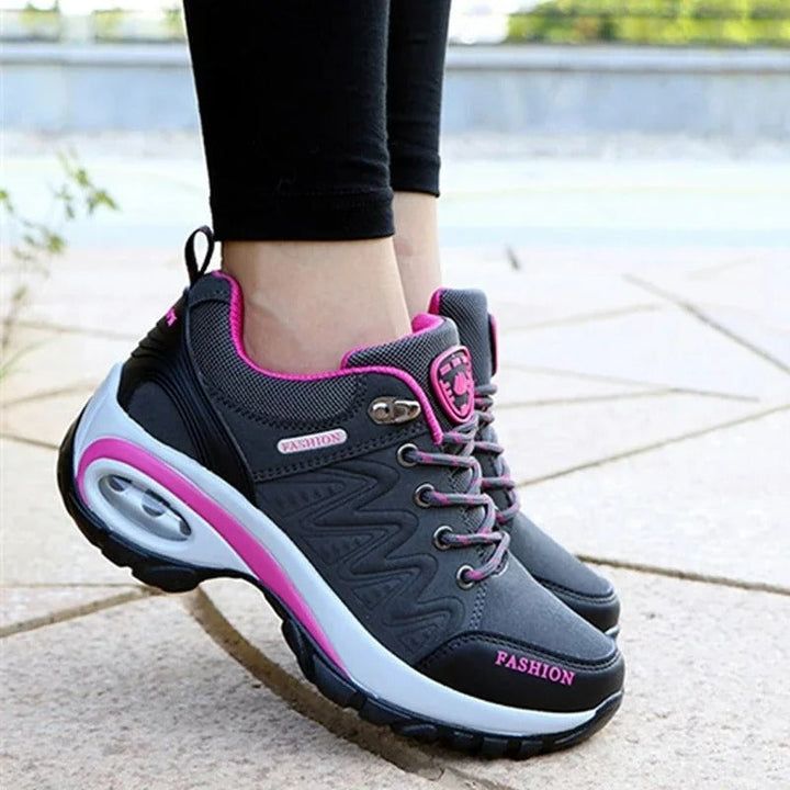 Close-up of pink orthopedic shoe insole demonstrating arch support