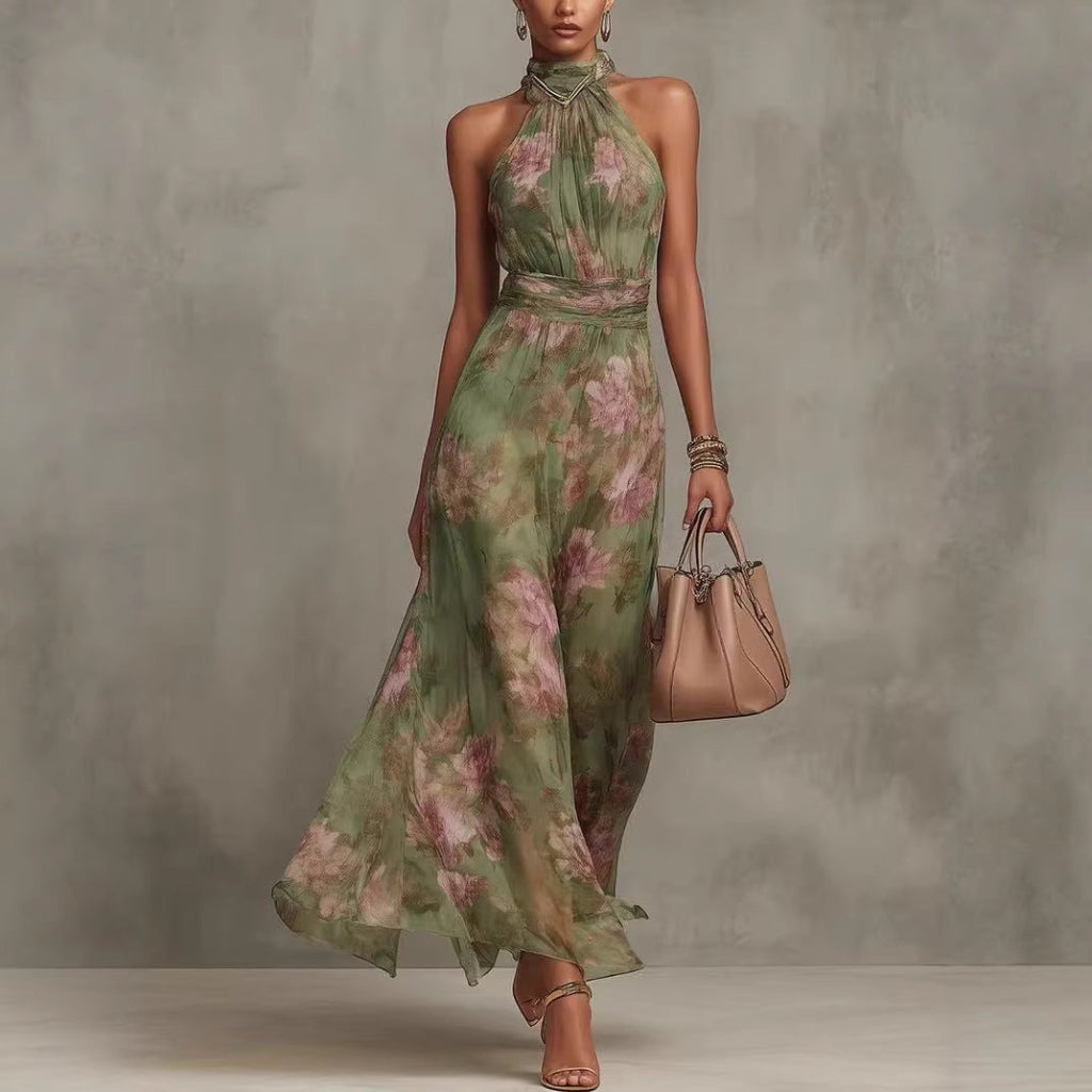 Model wearing a green floral resort-style waist-cinching dress with a handbag