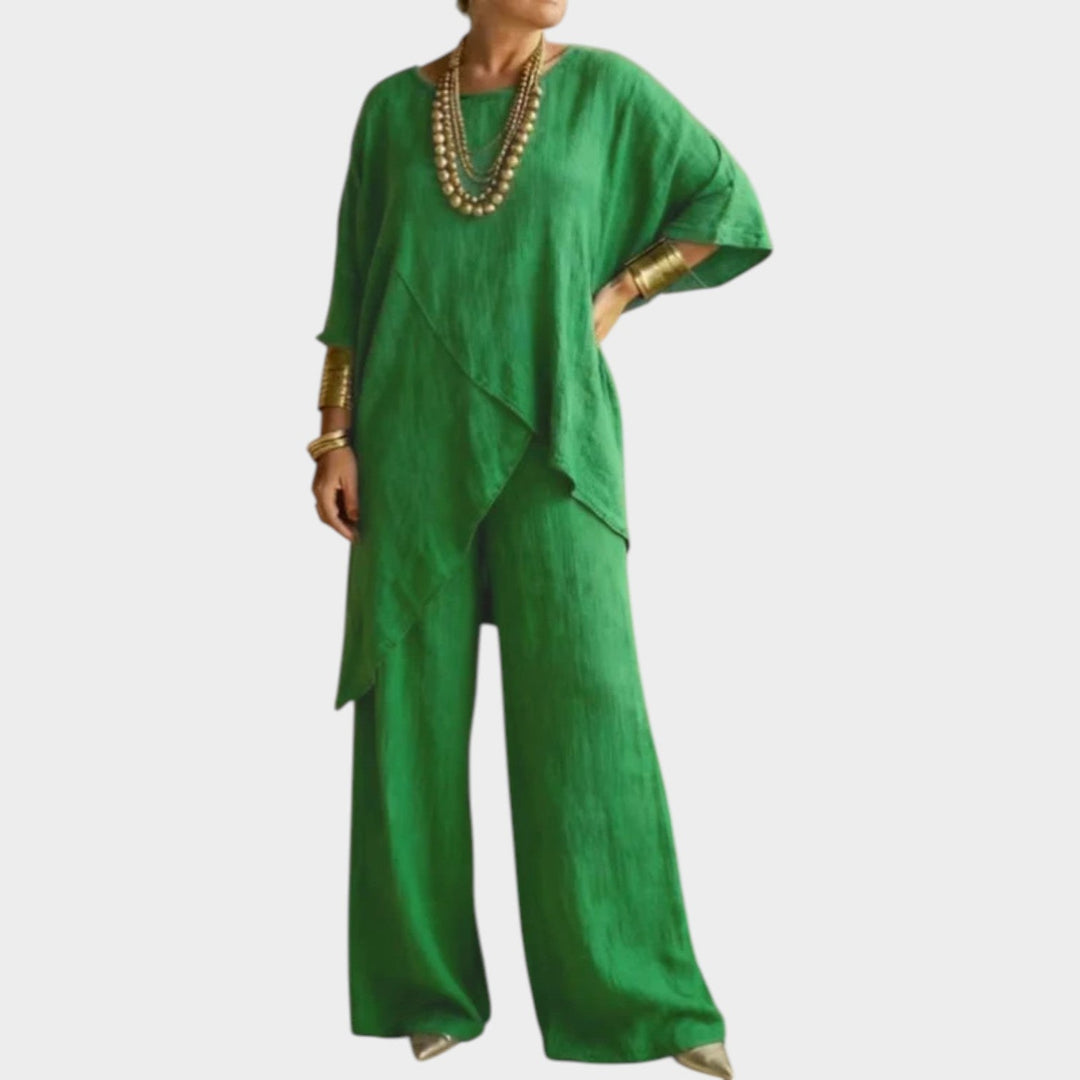 Woman wearing vibrant green asymmetrical two-piece outfit with wide-leg pants