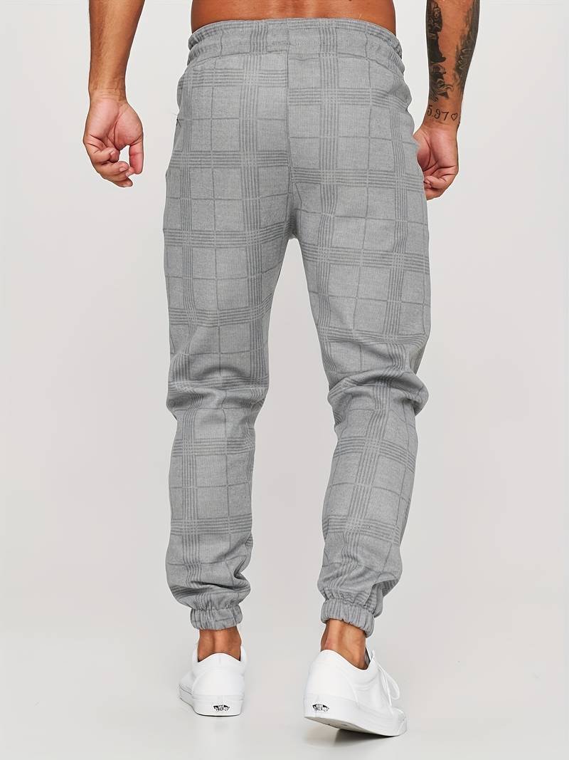 Men's modern checked jogger pants featuring an adjustable drawstring waist and tapered fit.