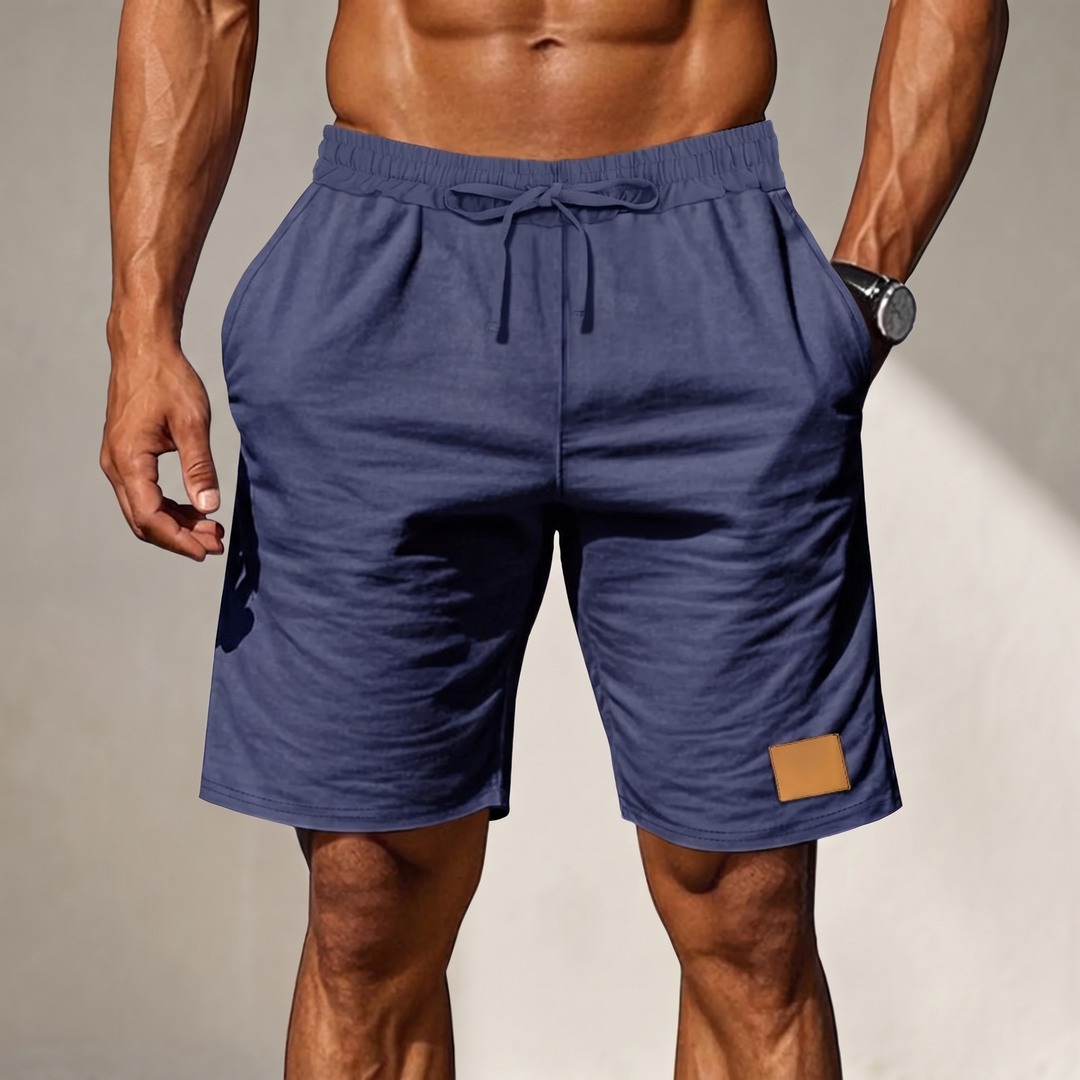 Man wearing navy drawstring comfort shorts in a casual setting