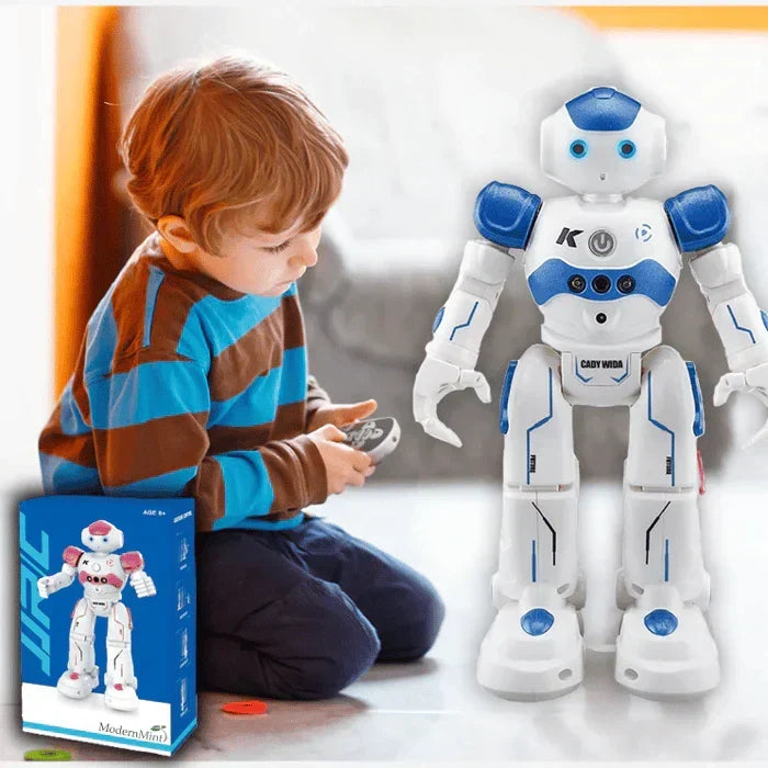 Young boy playing with blue smart interactive robot toy on floor