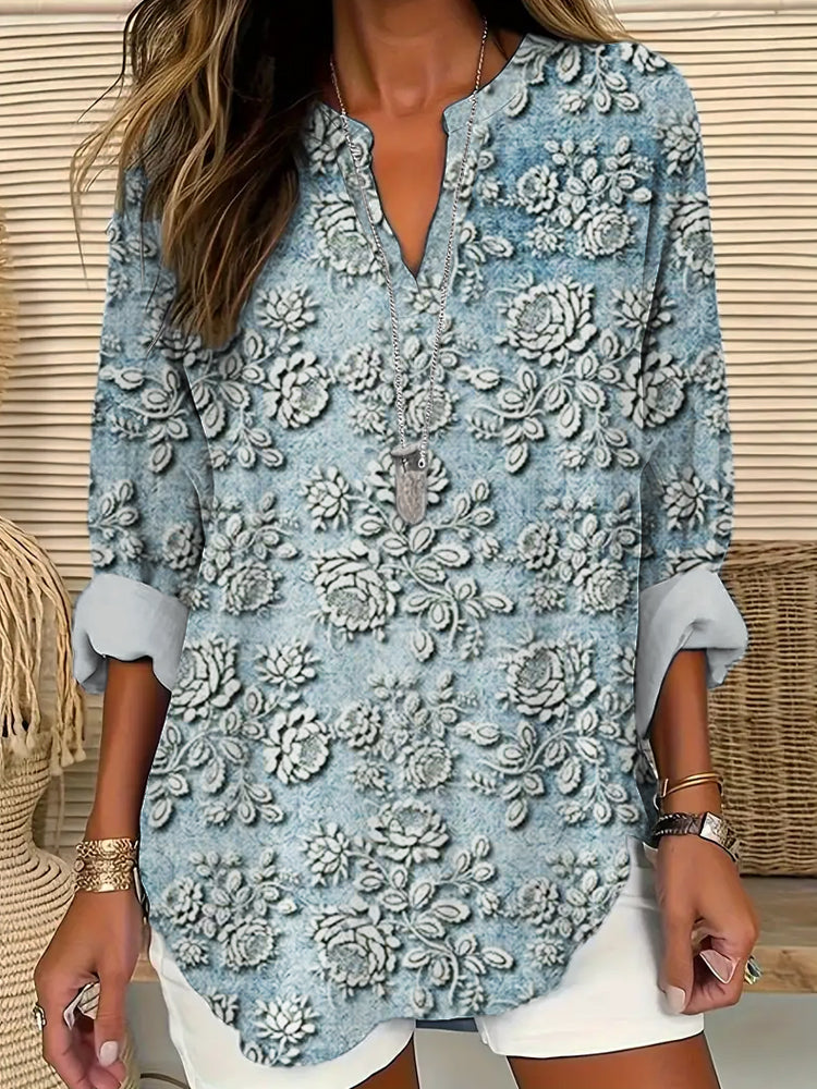 Woman wearing a blue printed long sleeve blouse with V-neckline