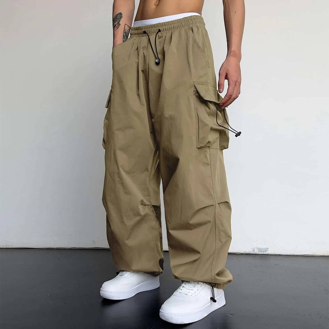Full view of khaki utility cargo jogger pants with elastic waist