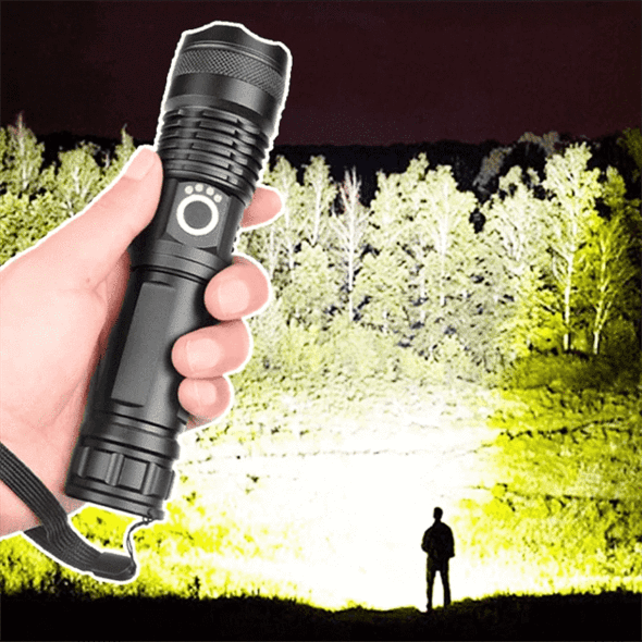 Tactical LED flashlight casting a powerful beam across trees in a dark environment