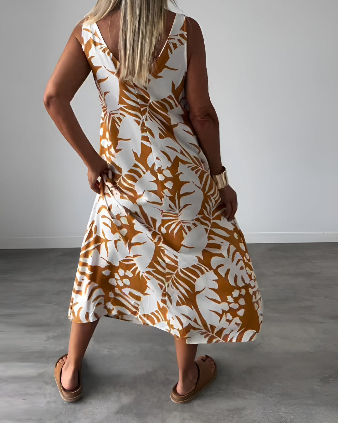 Full length view of a stylish women's elegant sleeveless summer dress