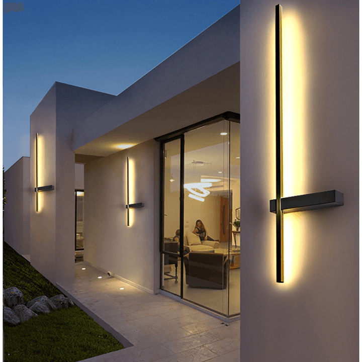 Modern black wall lamp for outdoor use shown against a neutral concrete background