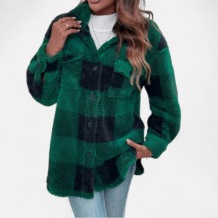 Model wearing women's long sleeve plaid shacket layered over a top for casual winter streetwear