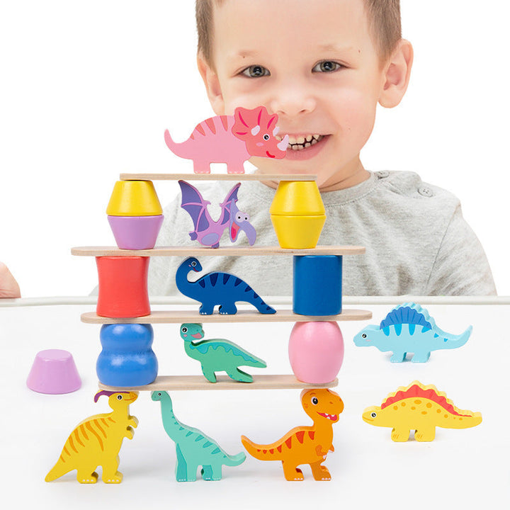 Smiling child playing with the colorful DinoStack dinosaur balancing and stacking game