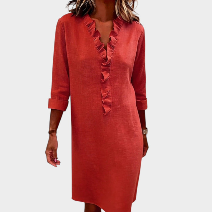 Woman wearing a red ruffle midi dress with long sleeves