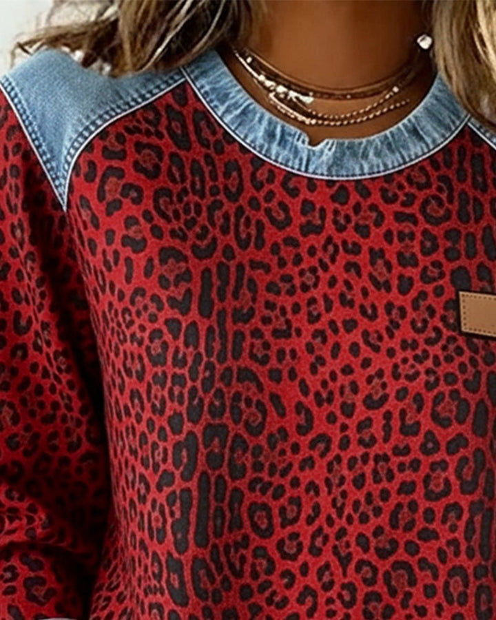 Folded women's animal print crew neck sweater on display