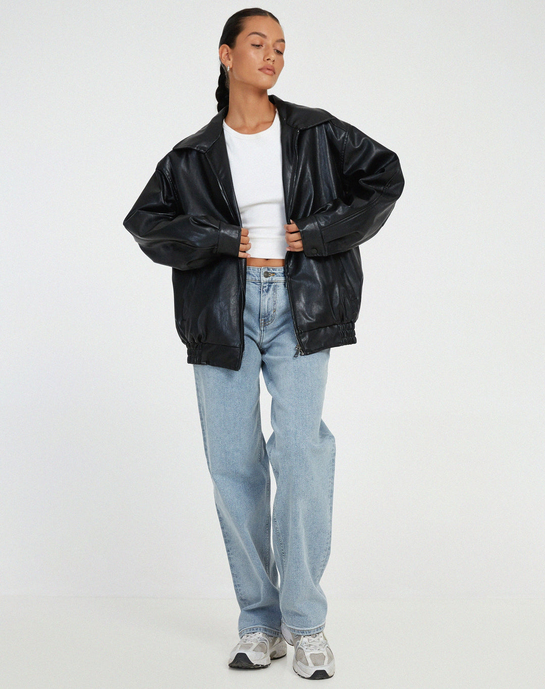 Model wearing black oversized biker jacket with jeans