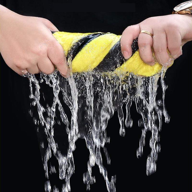 Person using the soft microfiber towel to dry a car hood without scratching.