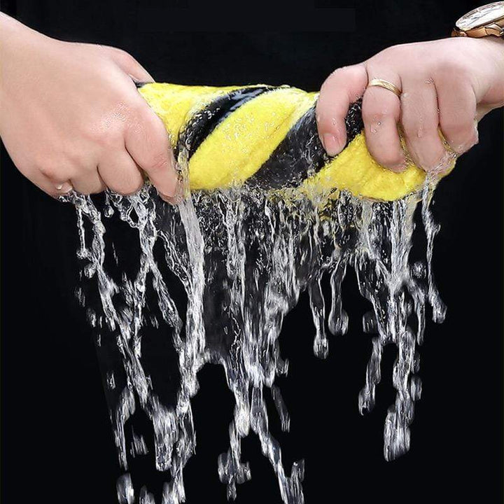 Person using the soft microfiber towel to dry a car hood without scratching.