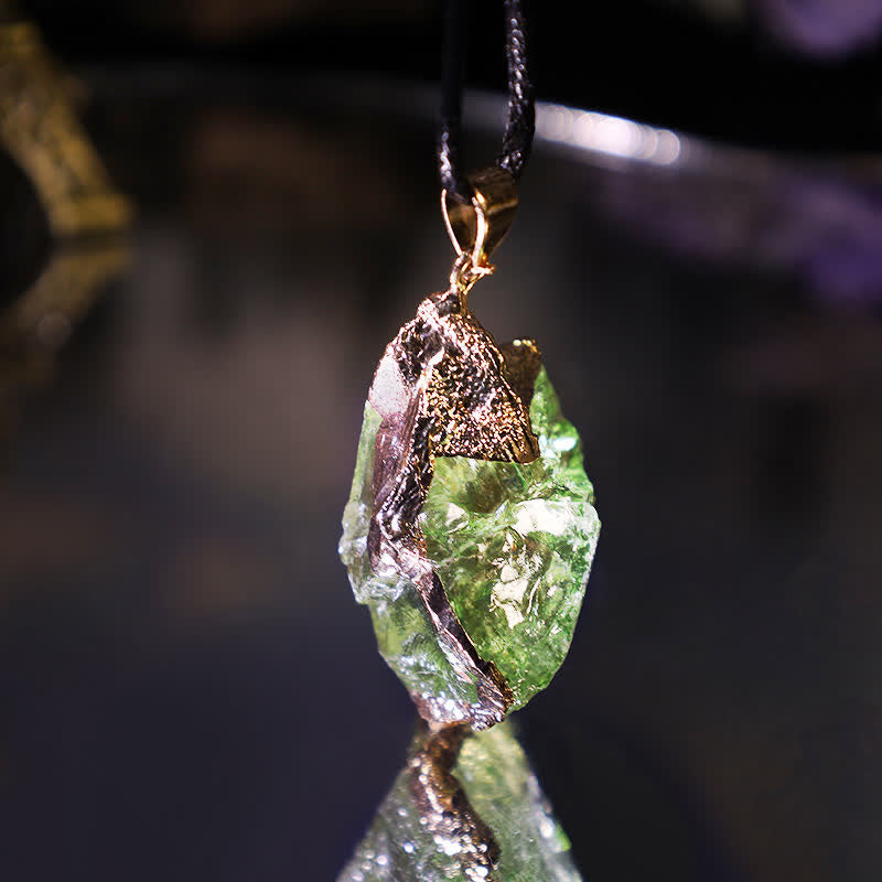 Handcrafted meteorite necklace featuring a genuine raw green crystal pendant