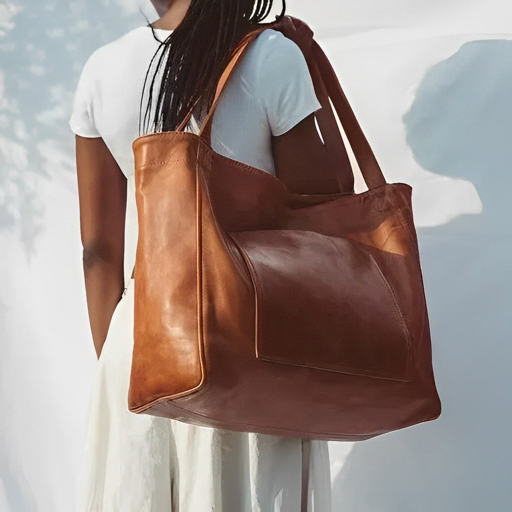 Woman wearing the brown vintage shoulder bag over her shoulder outdoors