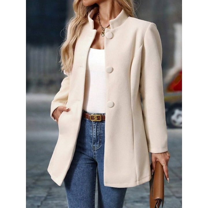 Close-up view of the front button closure and pocket detail on the trench coat