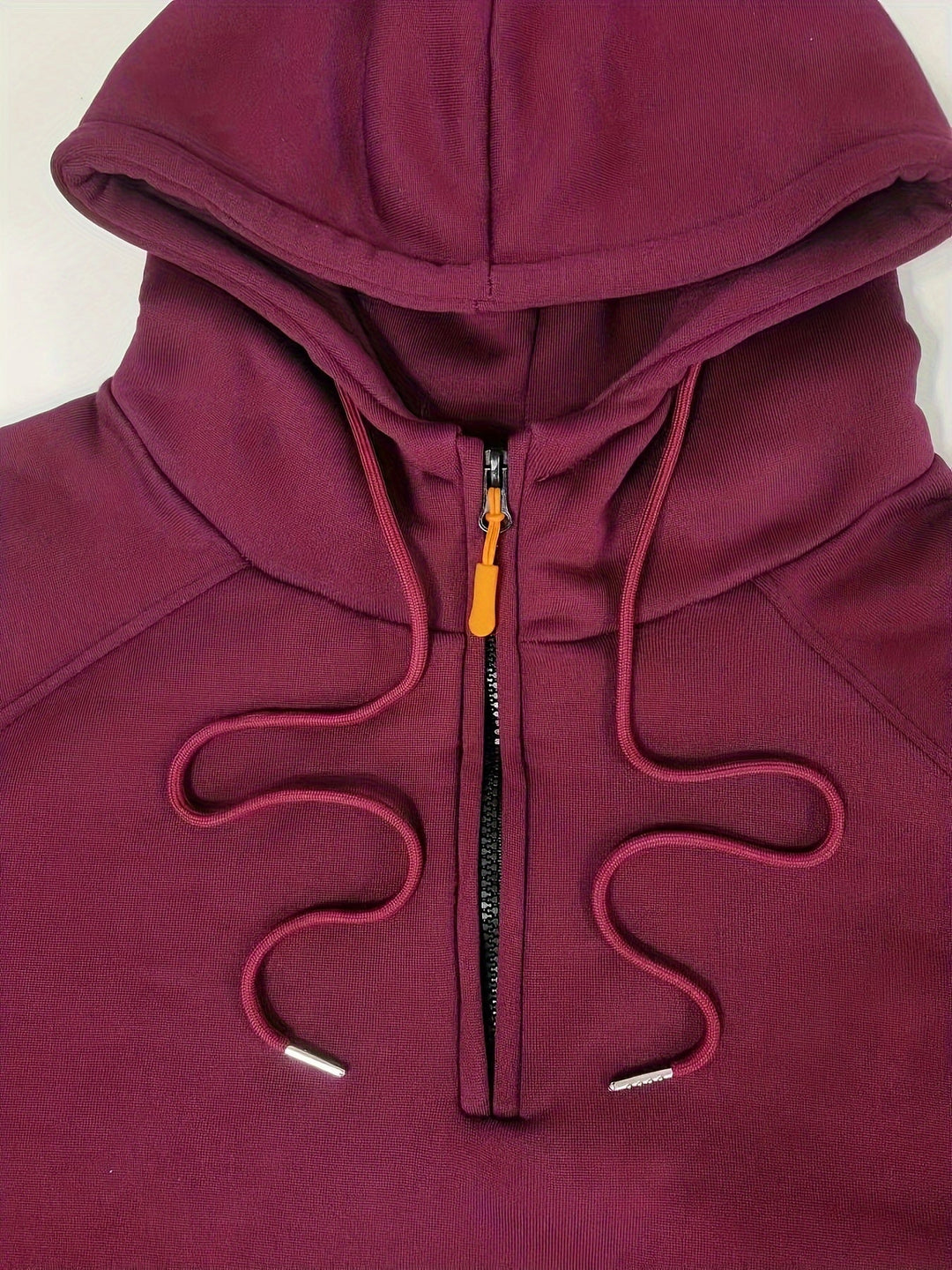 Detail of hood lining and drawstrings on men's casual pullover hoodie.