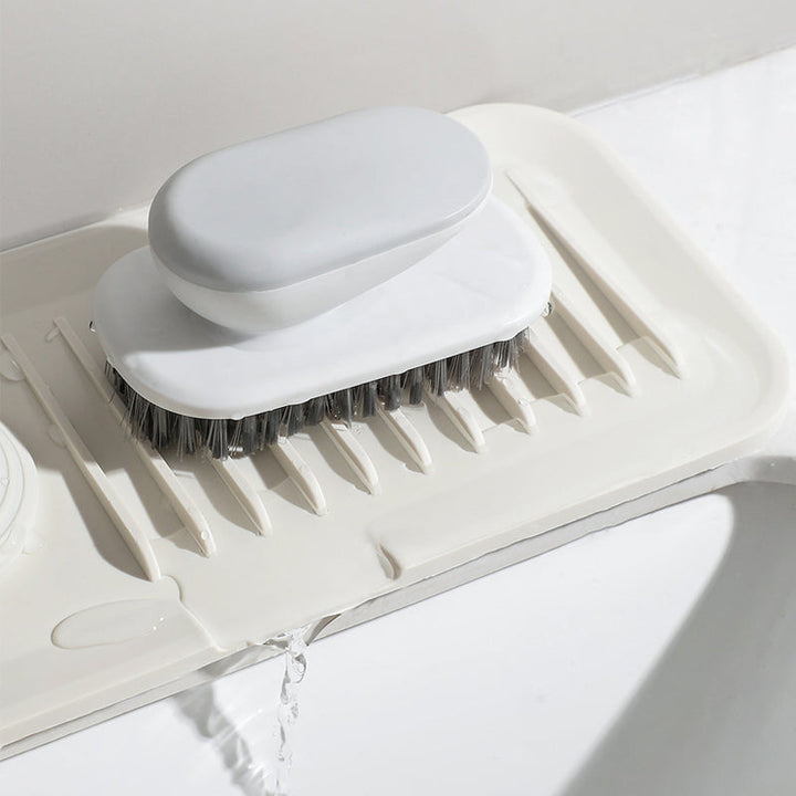 Flexible kitchen sink organizer mat showing ribbed drainage design