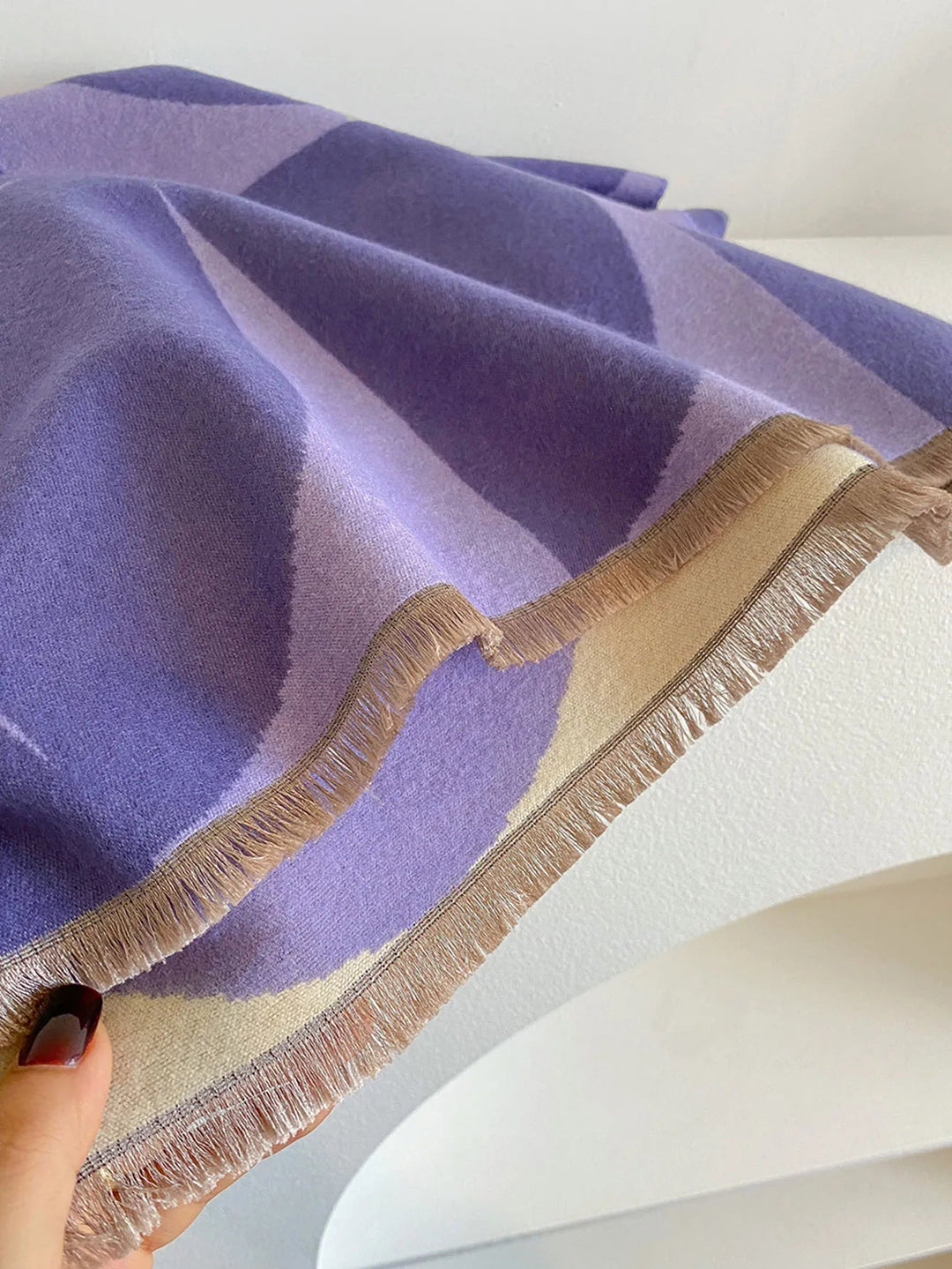 Detailed view of elegant purple and black women's scarf fabric