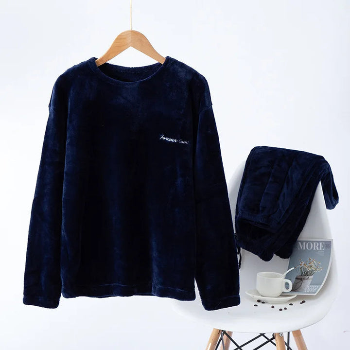Men's navy blue winter pyjama set displayed on chair