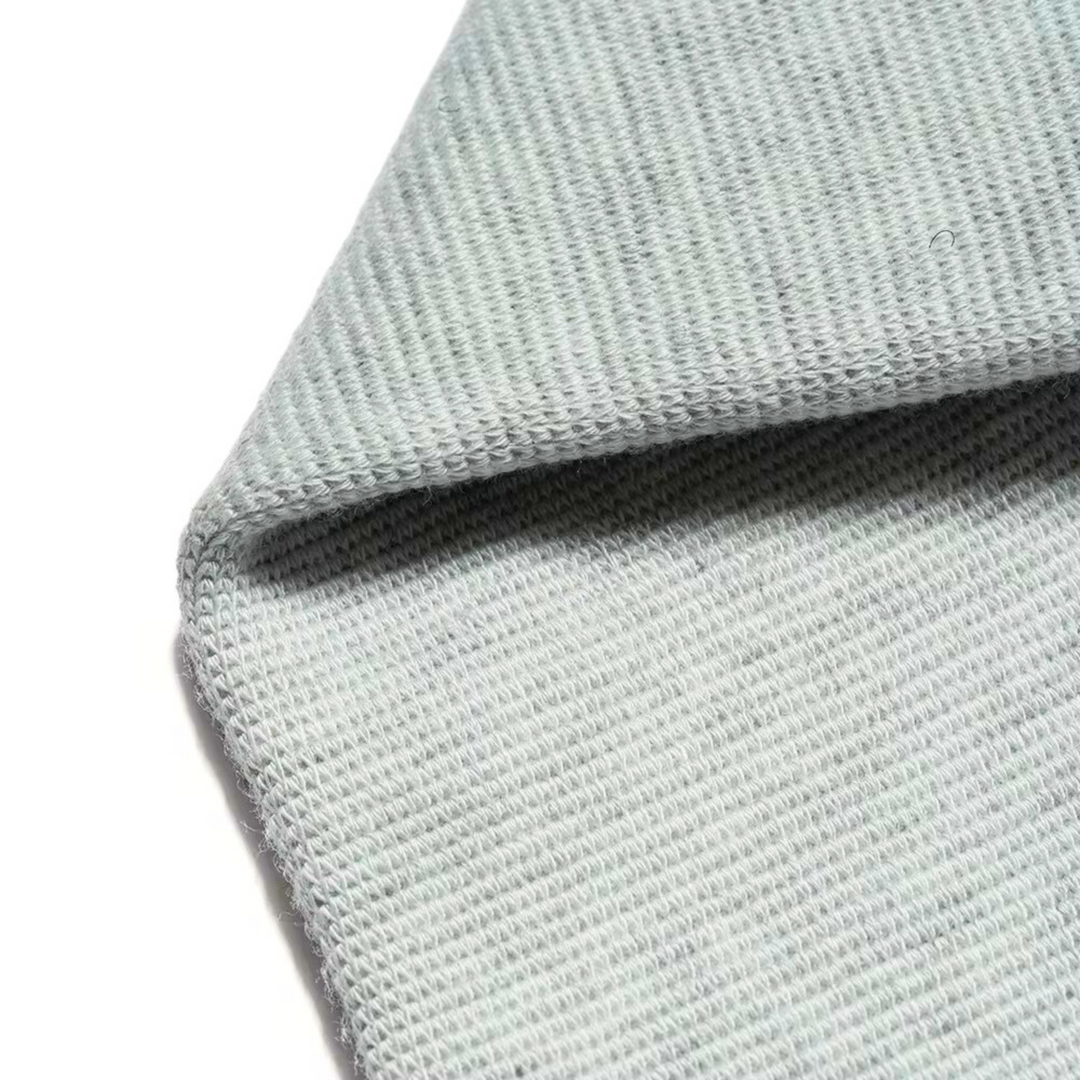 Flexible grey joint relief wrist sleeve laid flat for display