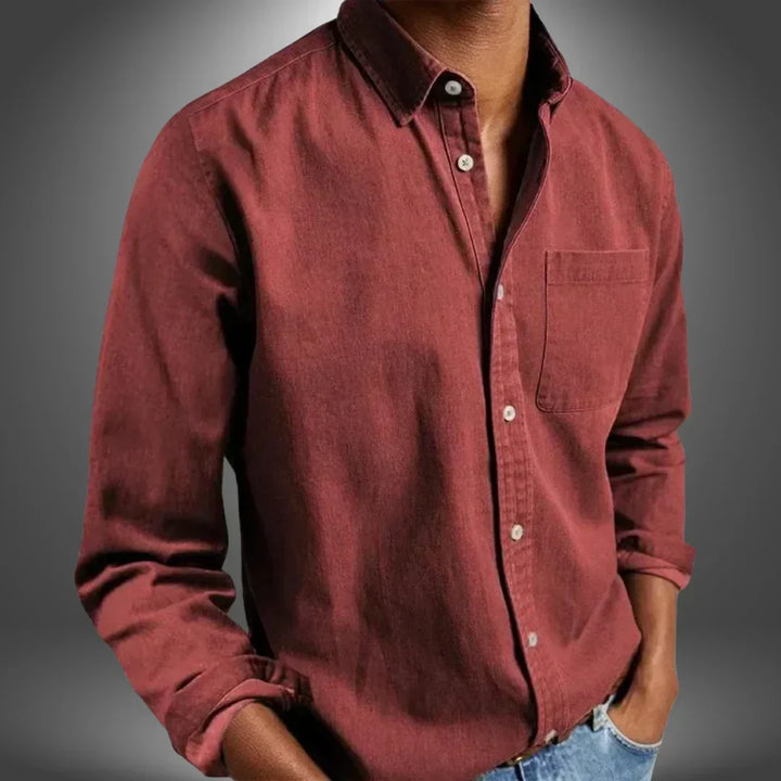 Folded stack of men's button-up shirts showing multiple colors