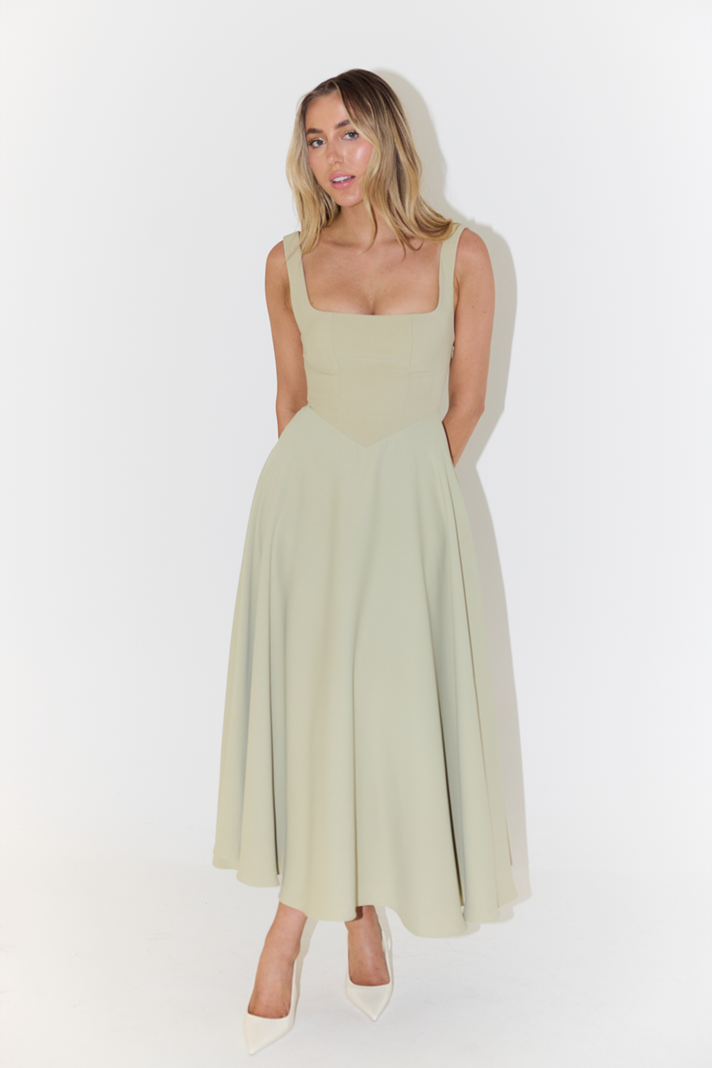 Back view of the elegant sage green casual midi dress