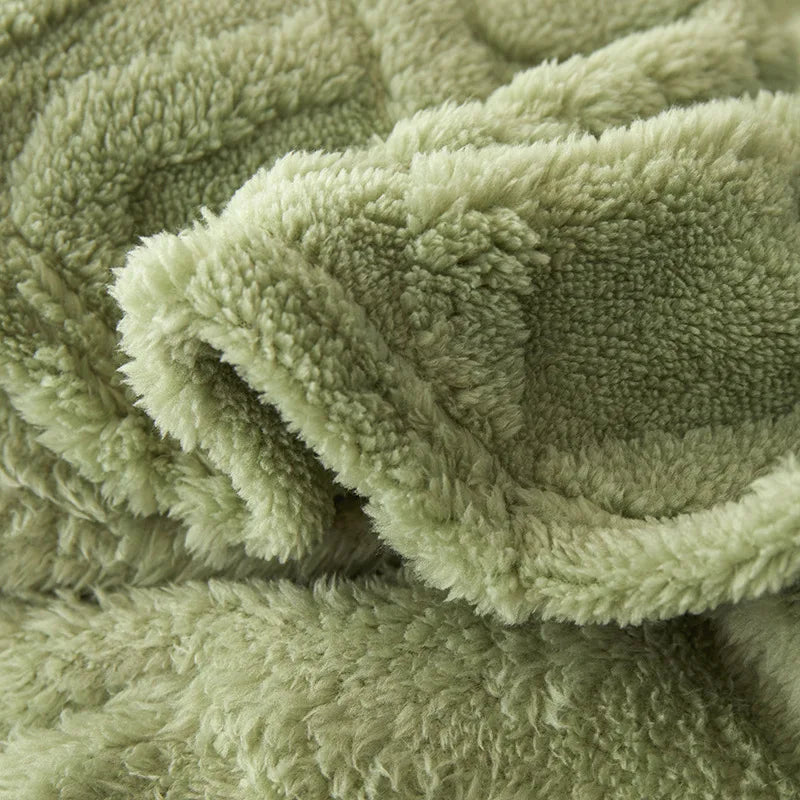 Close-up view of the soft textured fabric of the green bedroom blanket