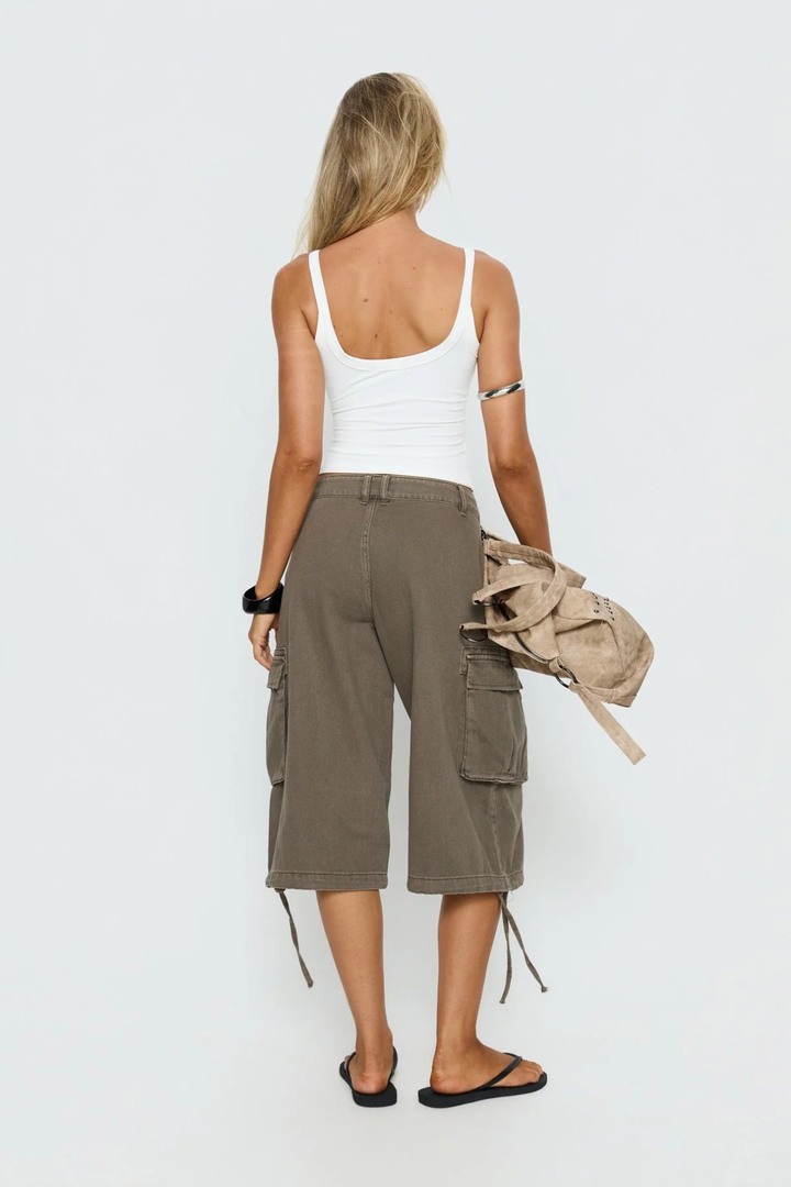 Detailed view of cargo strap accents on women's shorts