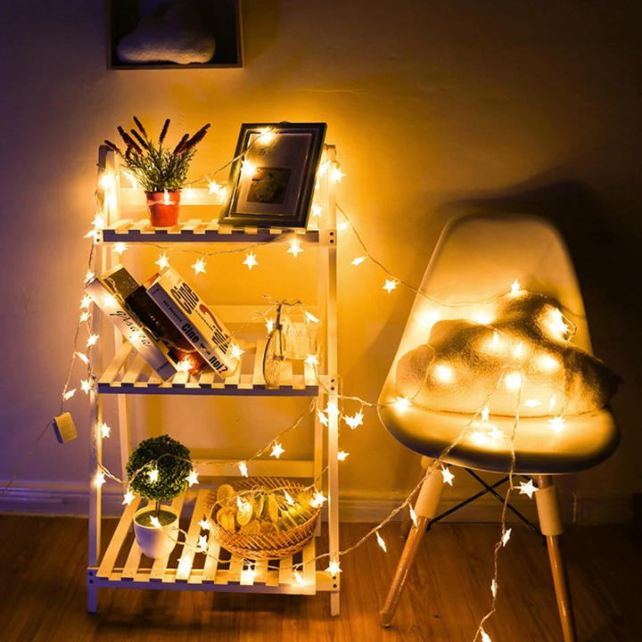 Close up of glowing star shaped fairy lights lit up for indoor party lighting