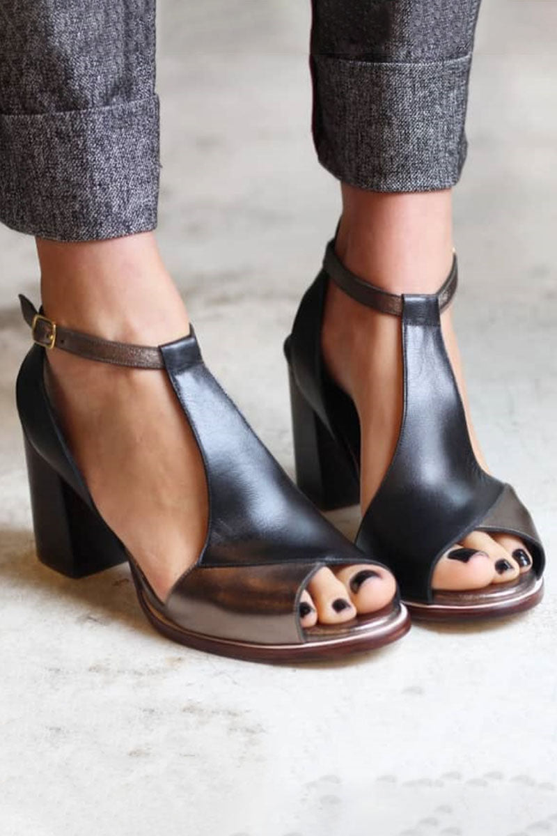 Close-up of black patchwork peep toe block heels with ankle strap