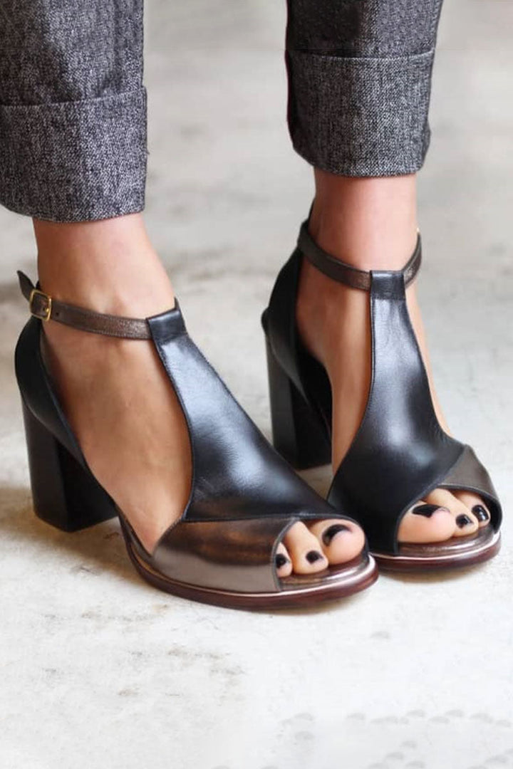 Close-up of black patchwork peep toe block heels with ankle strap