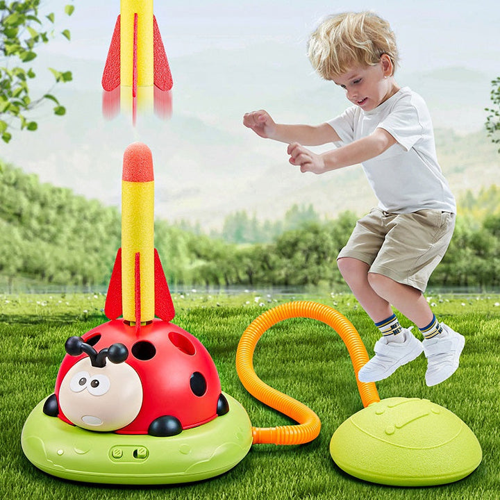 Child launching a pedal rocket outdoors with the colorful play equipment