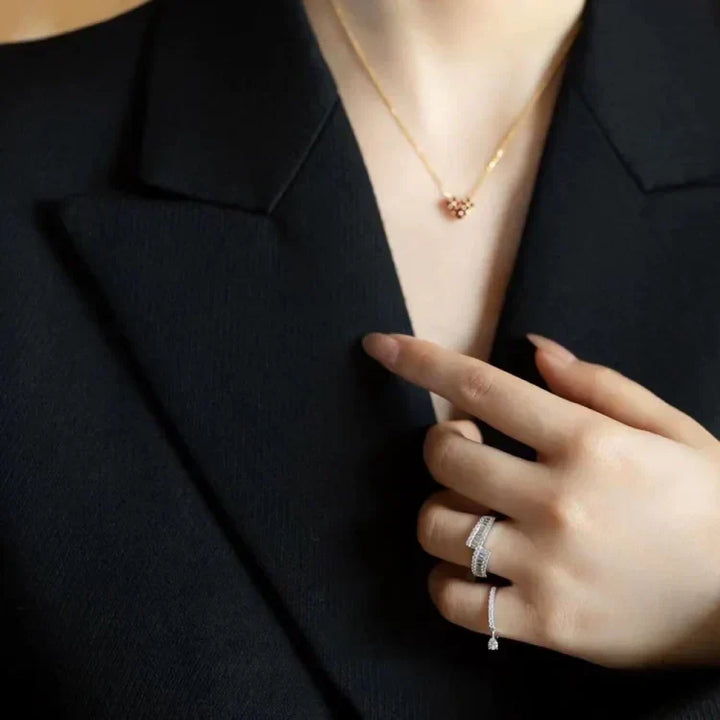 Model wearing silver teardrop ring with business attire