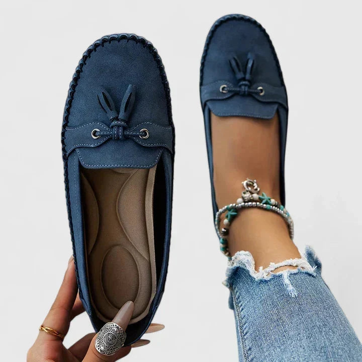 Blue women's slip-on loafers with moccasin stitching