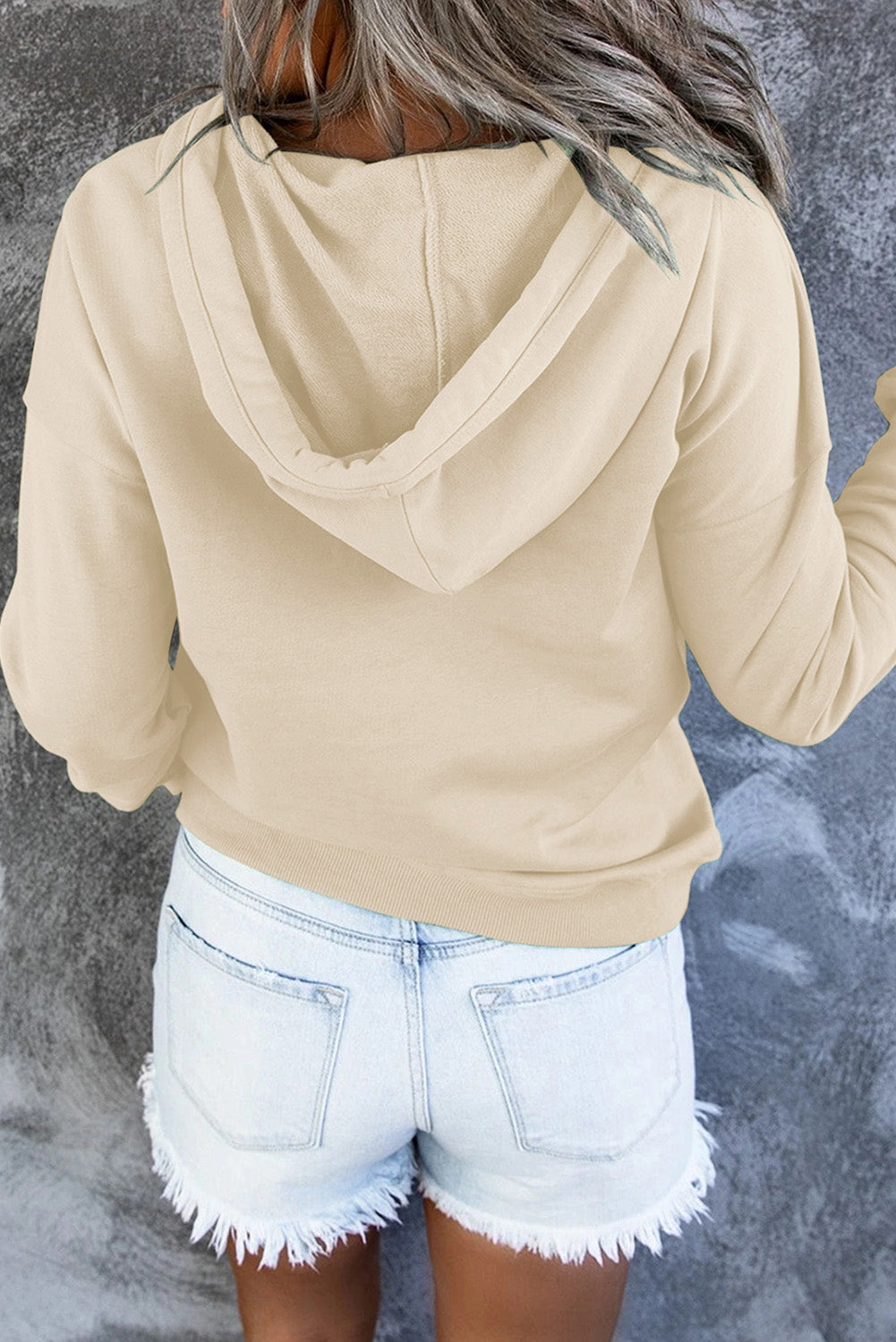 Product detail shot of the hood drawstring and eyelets