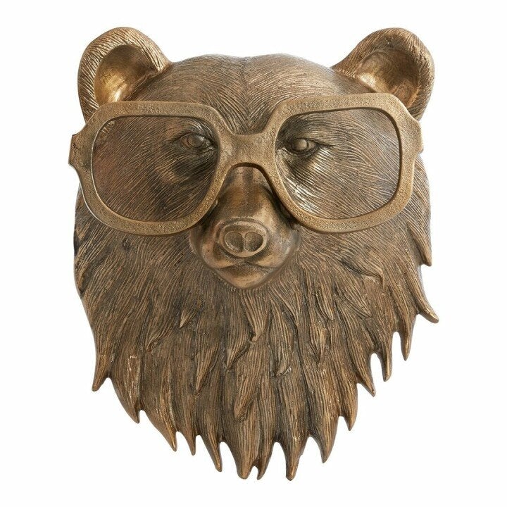 Front profile of a detailed bronze bear head wall decoration wearing wide framed glasses