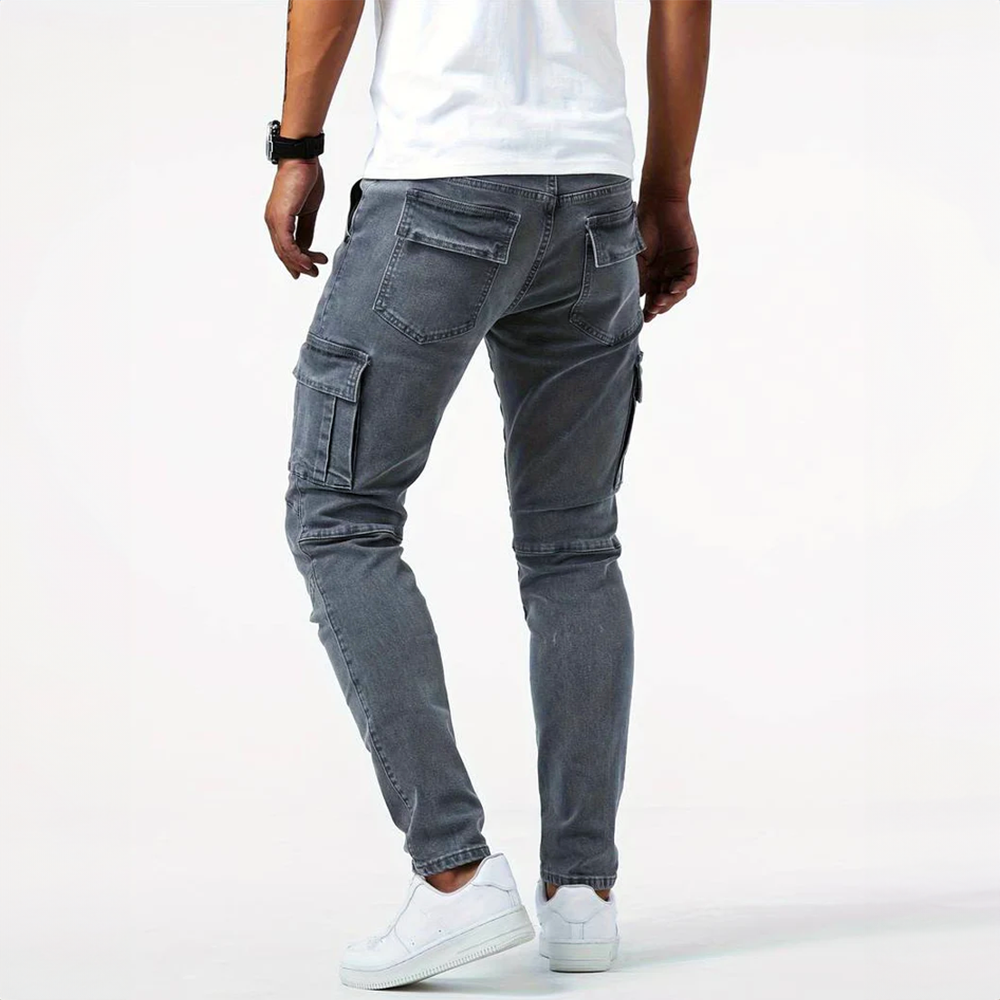 Man wearing grey slim fit cargo denim pants from the back view