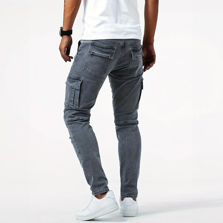Man wearing grey slim fit cargo denim pants from the back view