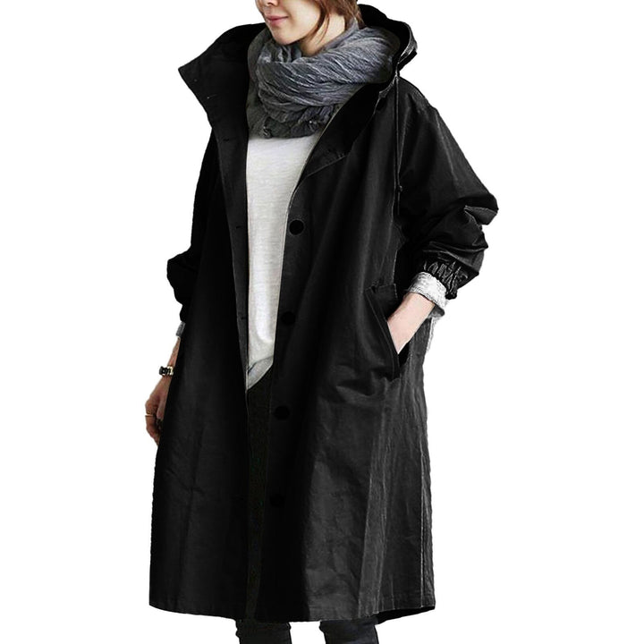 Woman wearing a black long waterproof raincoat with belt
