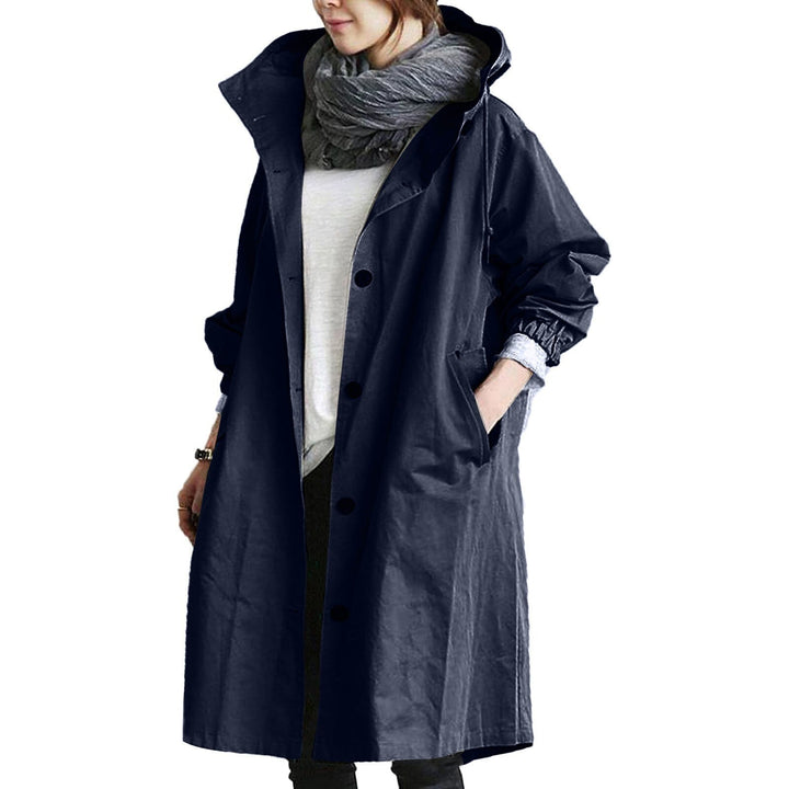 Woman wearing a dark blue long waterproof raincoat outdoors