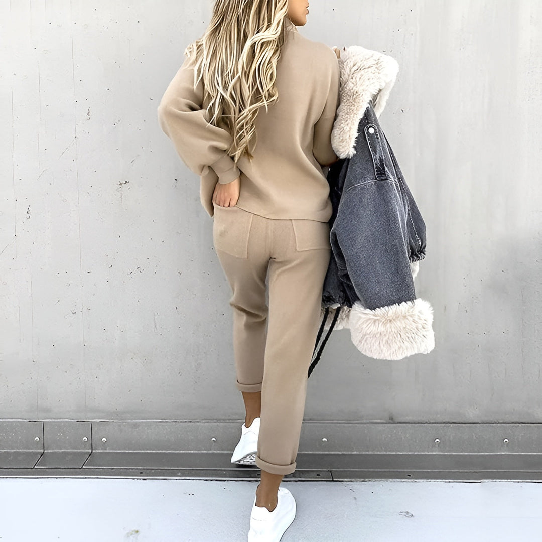 Back view of a woman wearing a khaki lounge suit walking outdoors