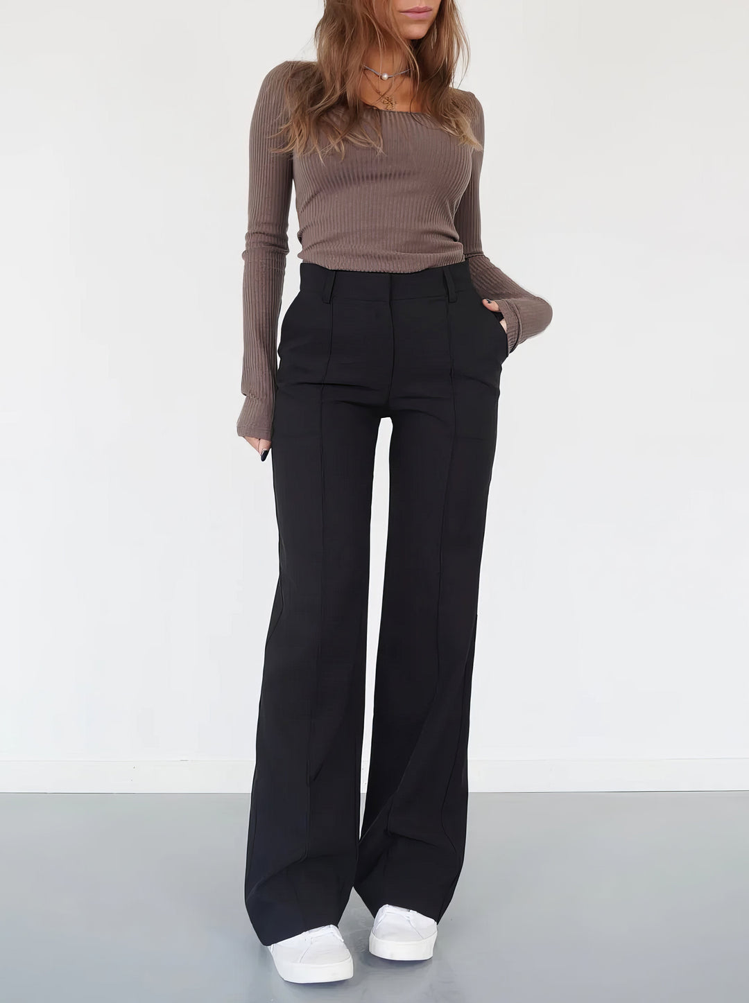 Woman wearing black wide-leg trousers from the front