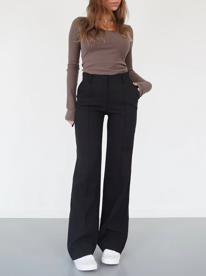 Woman wearing black wide-leg trousers from the front